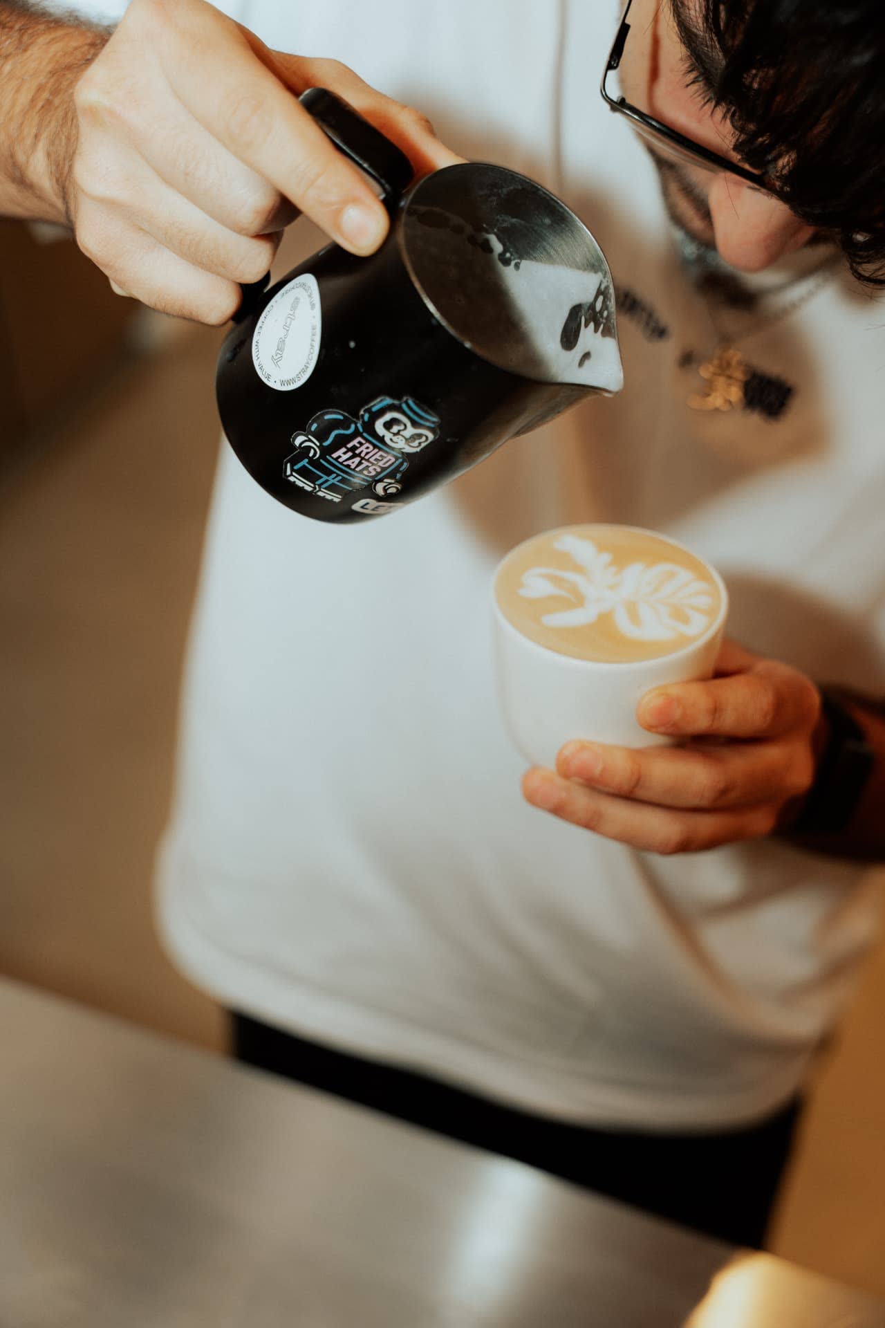 Barista schäumt Milch auf